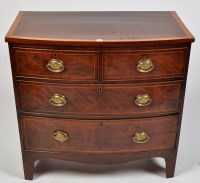 Lot 1106 - A George III mahogany bowfront chest of two...