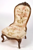 Lot 1116 - A Victorian walnut carved nursing chair, with...