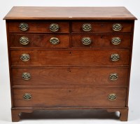 Lot 1132 - A George III mahogany chest of four short and...