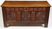 Lot 1137 - An 18th Century oak coffer, with carved leaf...