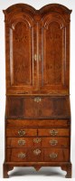 Lot 1152 - A George I and later walnut bureau bookcase,...