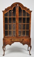 Lot 1155 - A Queen Anne style walnut display cabinet, the...