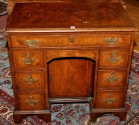 Lot 1156 - A George I style walnut kneehole desk, the...