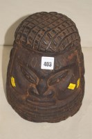 Lot 403 - An African carved wooden ornamental helmet in...