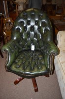 Lot 709 - A buttoned back leather office chair, raised...