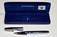 Lot 16 - A Sheaffer fountain pen, in white plated metal...