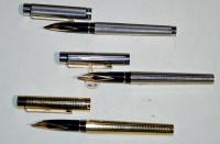 Lot 24 - Three Sheaffer fountain pens, two in silver...