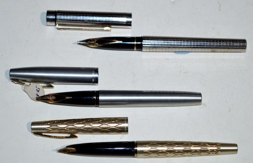 Lot 26 - Three Sheaffer fountain pens, one in silver...
