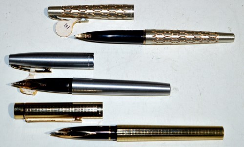 Lot 27 - Three Sheaffer fountain pens, one in silver...