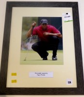 Lot 124 - A signed photograph of Tiger Woods, in glazed...