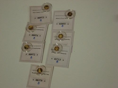 Lot 191 - Seven 14ct. gold miniature coins: 3 x 21st...