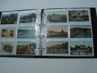 Lot 246 - An album of postcards, including: views of...
