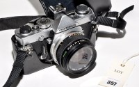 Lot 357 - An Olympus OM-1N SLR camera (chrome), fitted a...