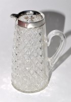 Lot 528 - A George V cut glass jug with silver rim and...