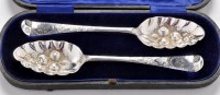 Lot 575 - A pair of early George III berry spoons, maker...