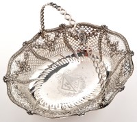 Lot 623 - A George III swing handled cake basket, by...