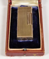 Lot 639 - A mid 20th Century 9ct. gold cigarette lighter...