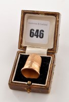 Lot 646 - A George V 9ct. gold thimble, by James Swann &...