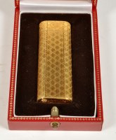 Lot 658 - Cartier, Paris: a gold plated cigarette...