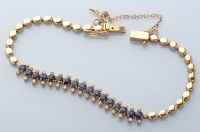 Lot 714 - A sapphire and yellow metal bracelet,...