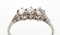 Lot 718 - A three stone diamond ring, the three...