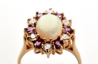 Lot 720 - An opal, ruby and diamond ring, the oval opal...