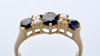 Lot 724 - A sapphire and diamond ring, the three...