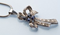 Lot 726 - A sapphire and diamond drop pendant of bow...