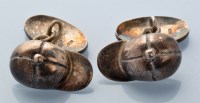 Lot 728 - A pair of silver cufflinks in the form of...