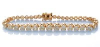 Lot 730 - A diamond tennis bracelet, the thirty nine...