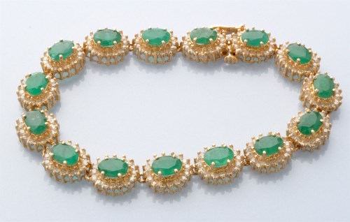Lot 731 - An emerald and diamond bracelet, made up of...
