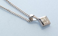 Lot 737 - A diamond pendant, set with four princess cut...