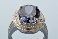 Lot 739 - A tanzanite and diamond cluster ring, the oval...