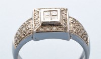 Lot 749 - A diamond dress ring, the four princess cut...