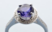 Lot 771 - A purple sapphire and diamond cluster ring,...