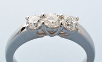 Lot 773 - A three stone diamond ring, with three...