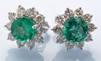 Lot 775 - A pair of emerald and diamond cluster earrings,...