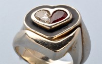 Lot 780 - A diamond, ruby and enamel heart-shaped ring,...