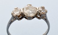 Lot 787 - A three stone diamond ring, the central...