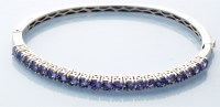 Lot 799 - A tanzanite bangle, the twenty-one circular...