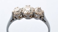 Lot 803 - A three-stone diamond ring, the old cut...