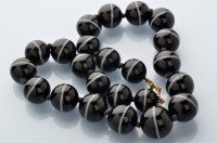 Lot 810 - A banded agate bead necklace, the graduated...