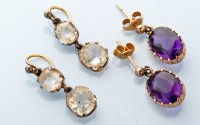 Lot 827 - A pair of amethyst drop earrings, each oval...