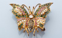 Lot 832 - A gem set butterfly brooch, set throughout...