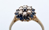 Lot 837 - A sapphire and diamond cluster ring, the...