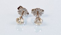 Lot 847 - A pair of diamond stud earrings, the brilliant...