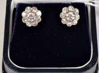 Lot 848 - A pair of diamond cluster earrings, each with...