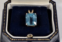 Lot 849 - A blue topaz pendant, the faceted canted...