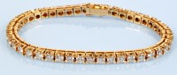 Lot 851 - A diamond line bracelet, the single row of...