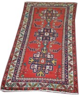 Lot 1140 - A Persian rug, three geometric medallions to...